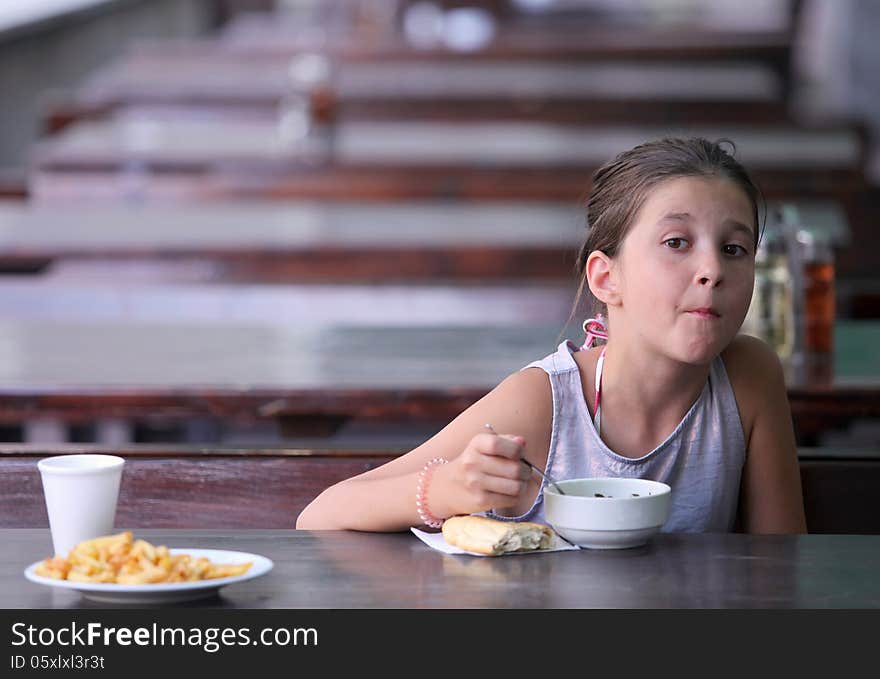 Girl having lunch at an outdoor restaurant. Girl having lunch at an outdoor restaurant