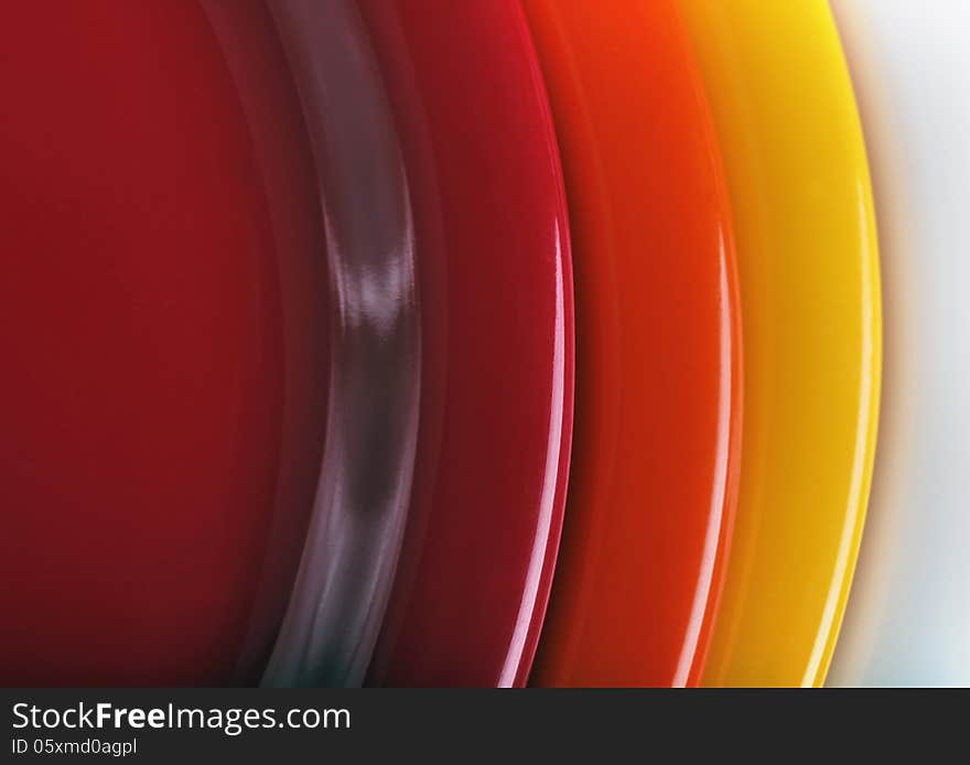 Orange, Yellow And Red Colored  Plates Stacked Upon Each Other