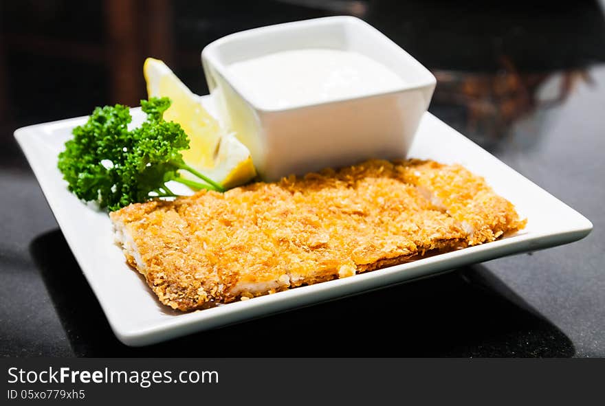 Fried bread crumbs pork and lemon mayonnaise with parsley