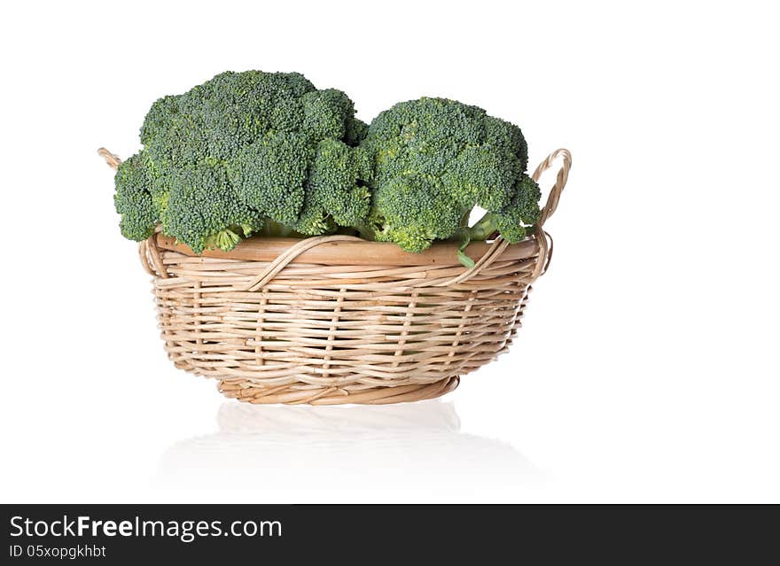 Two broccolies in a basket isolated on white background. Two broccolies in a basket isolated on white background.