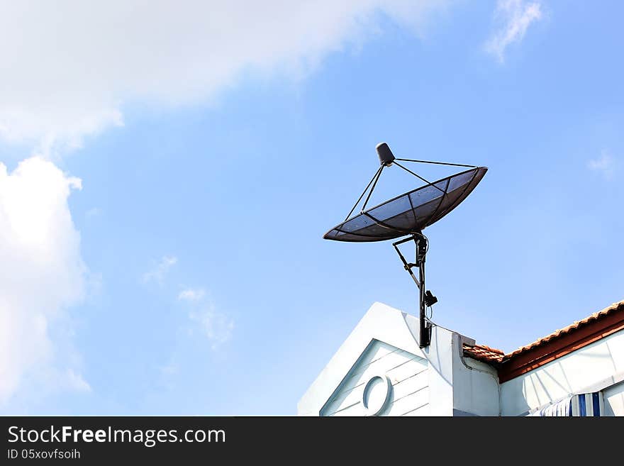 Satellite dish on roof with beautiful sky