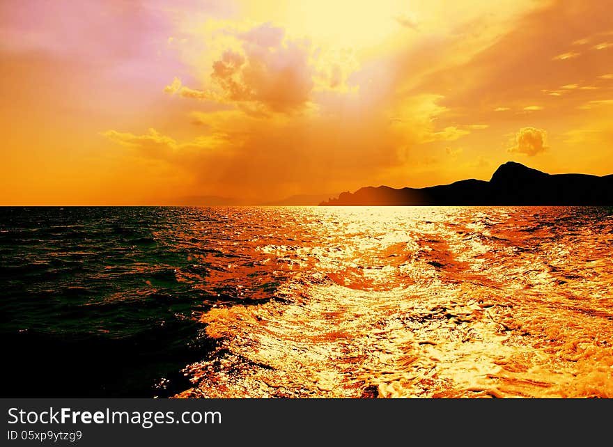 Beautiful view of Black Sea with dark mountains on horizon under clouds