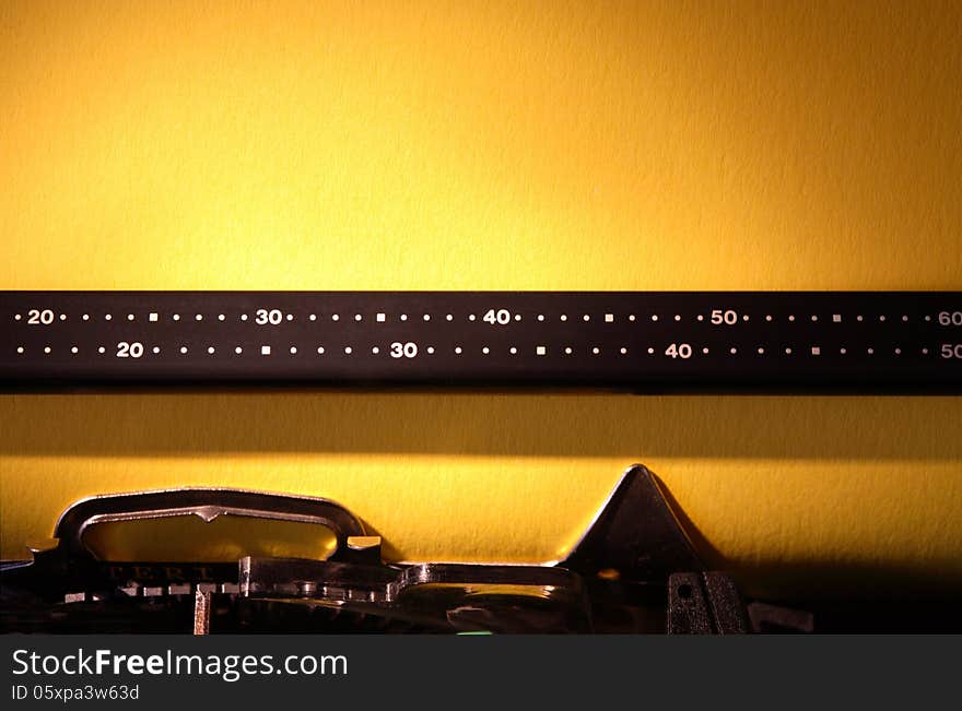 Electrical typewriter closeup with blank yellow paper sheet for your text. Electrical typewriter closeup with blank yellow paper sheet for your text