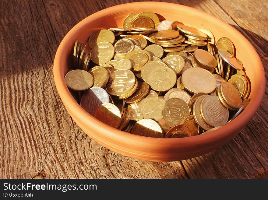 Coins on brown baclground of wooden