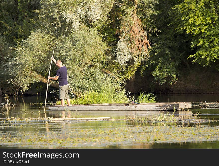 Life by the river. Man on the old wooden rowboat. Life by the river. Man on the old wooden rowboat.