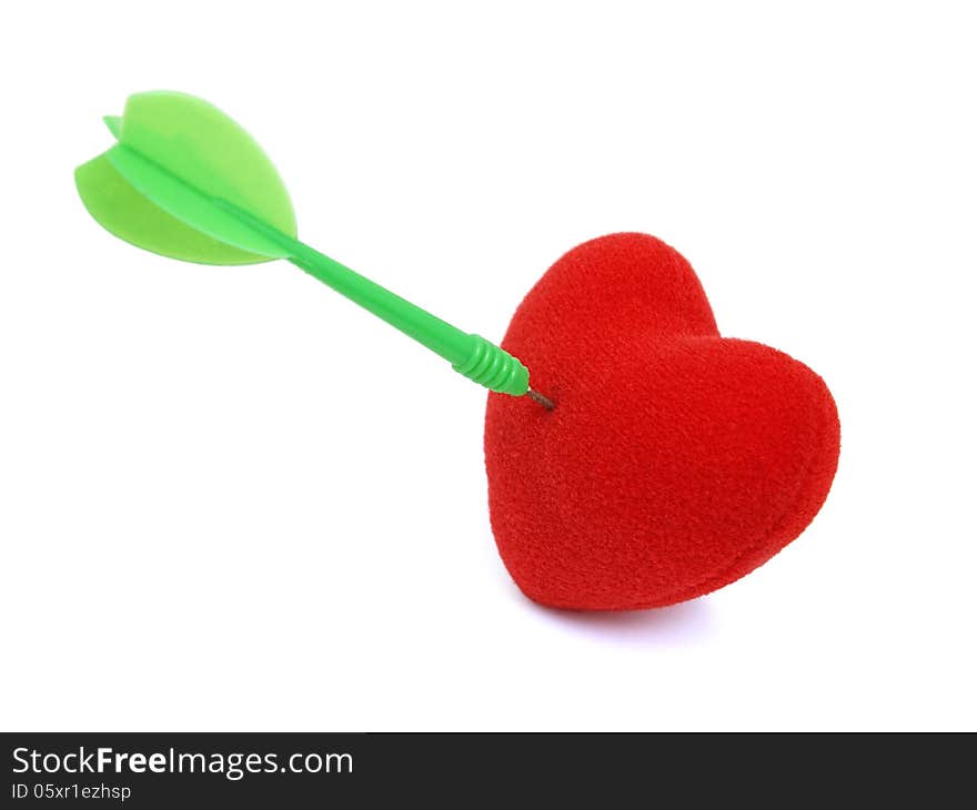 Red heart stabbed by green dart on white background. Red heart stabbed by green dart on white background