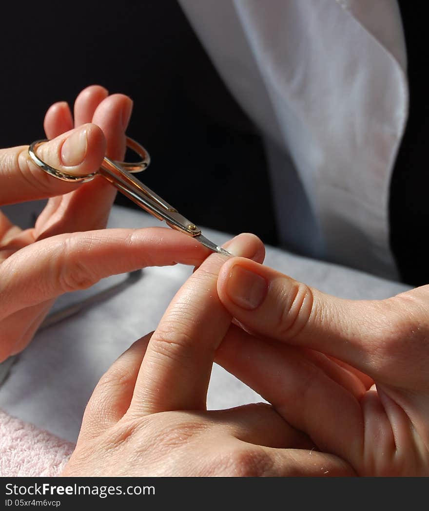 Manicurist professional cutting cuticles of the fingers. Manicurist professional cutting cuticles of the fingers