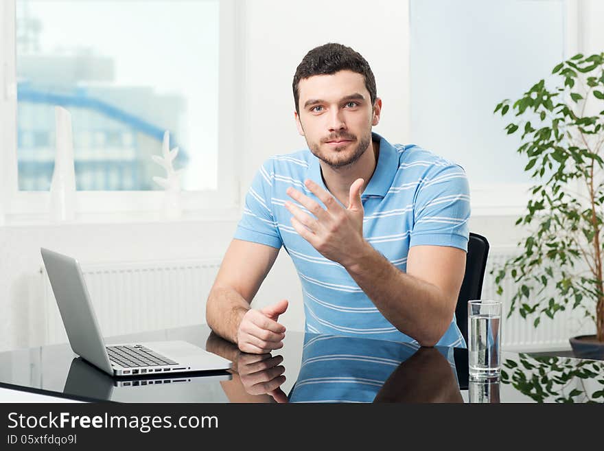 Businesswoman sitting at table with laptop