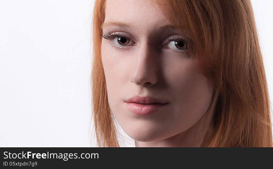 A close up portrait of a gorgeous young woman with red hair. A close up portrait of a gorgeous young woman with red hair