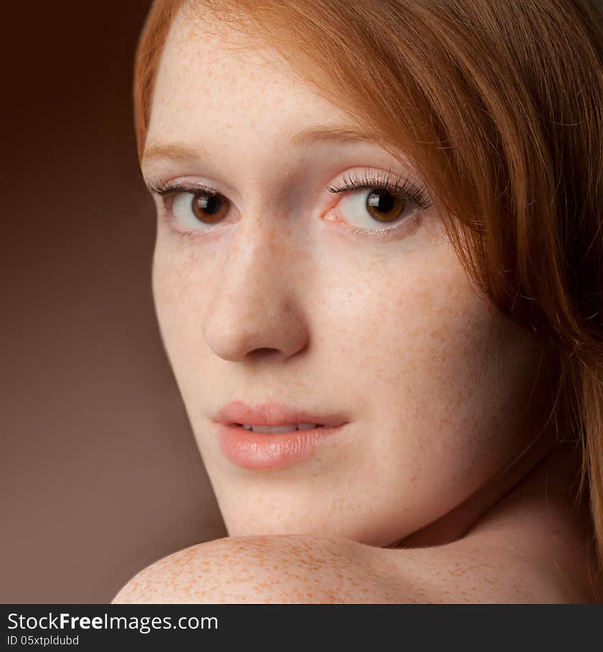 A close up of a pretty young woman with freckles and red hair. A close up of a pretty young woman with freckles and red hair