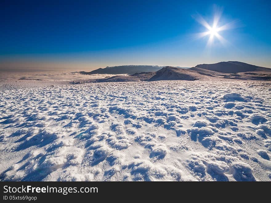 Sun and snow mountains landscape