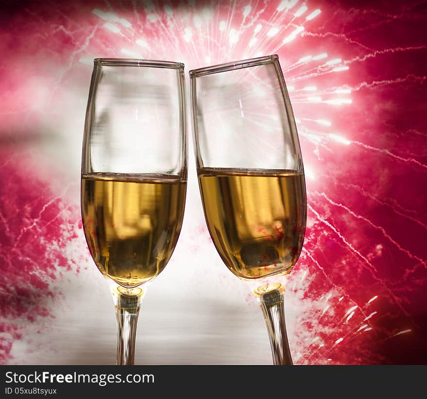 Glasses with champagne against fireworks