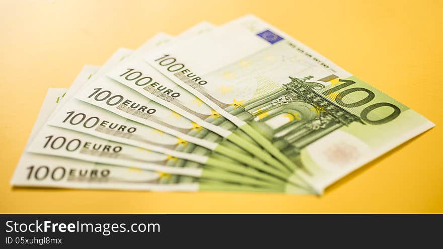 100 euro bills on gold backgrond