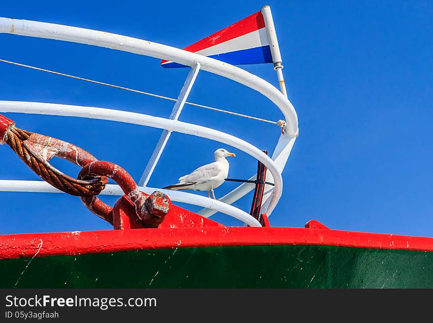 A seagull on the forepart of a fishing ship. A seagull on the forepart of a fishing ship.