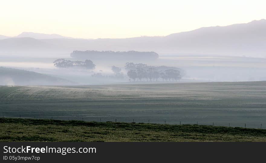 Landscape with mountains and fields at dawn. Landscape with mountains and fields at dawn