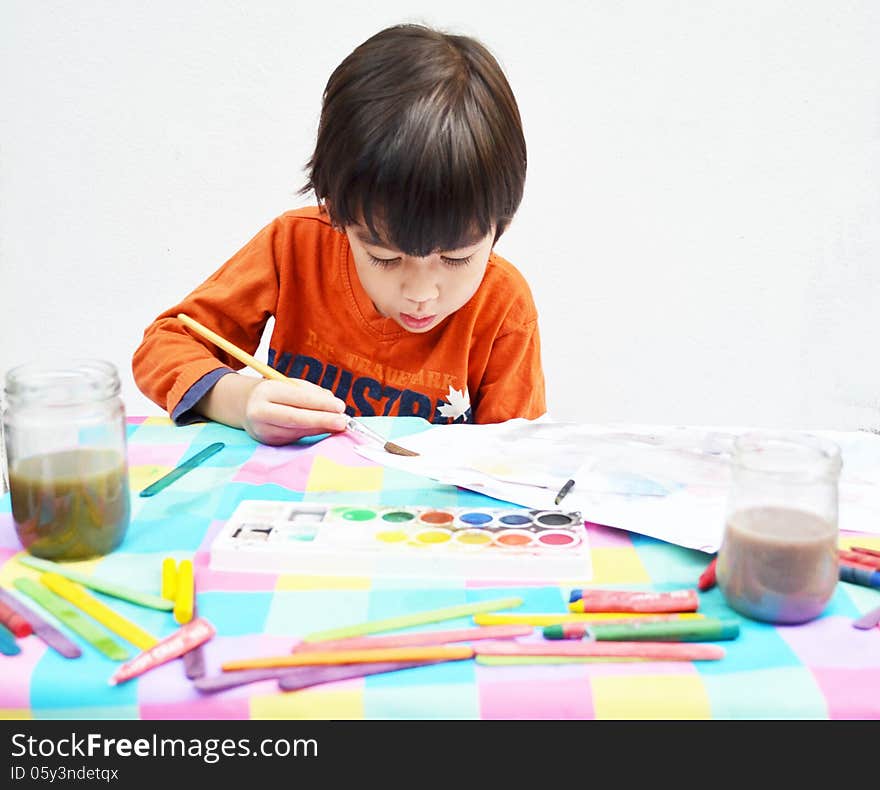 Little boy painting water color