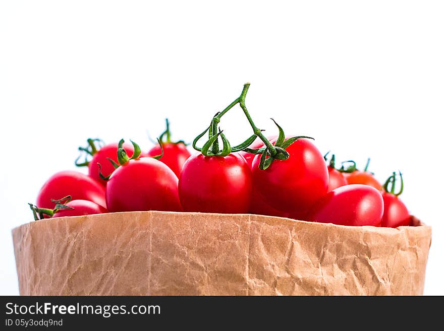 Tomatoes in paper bag isolated on white