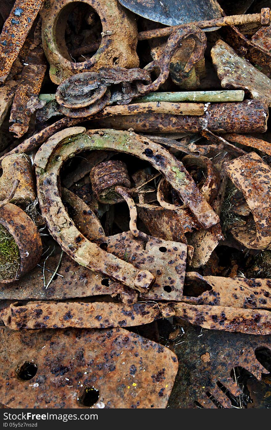 Rusty antique horseshoe with other rusted metal from stockpile on farm. Rusty antique horseshoe with other rusted metal from stockpile on farm.