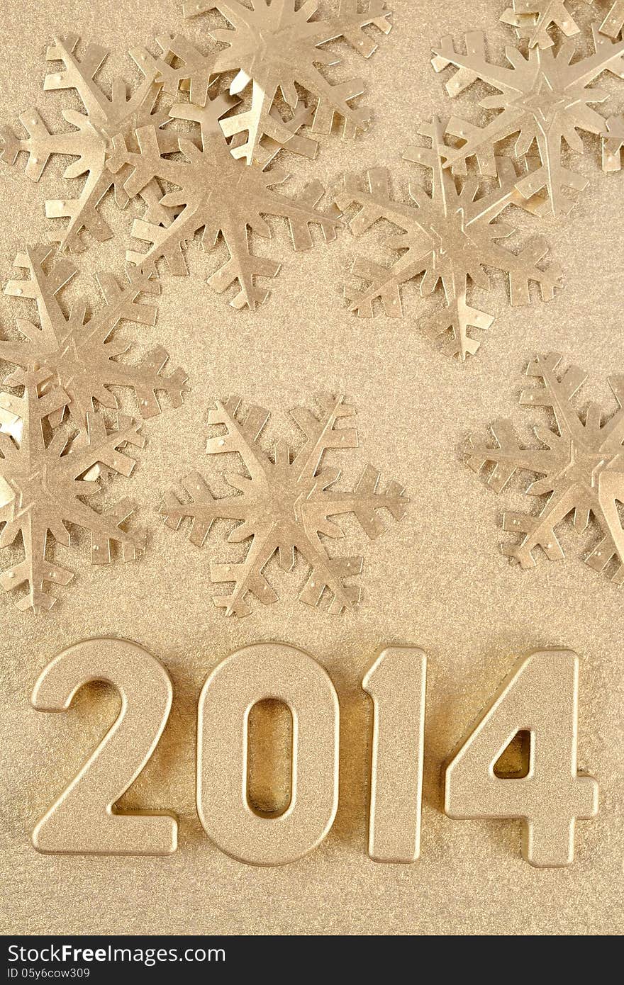 2014 year golden figures on the background of golden snowflakes