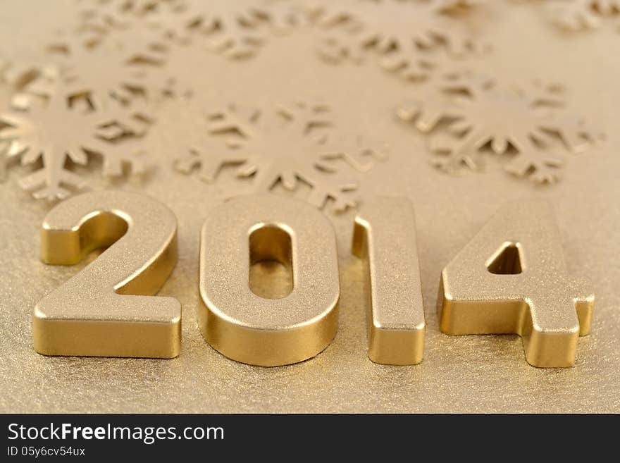 2014 year golden figures on the background of golden snowflakes