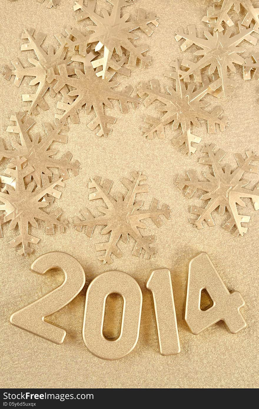 2014 year golden figures on the background of golden snowflakes