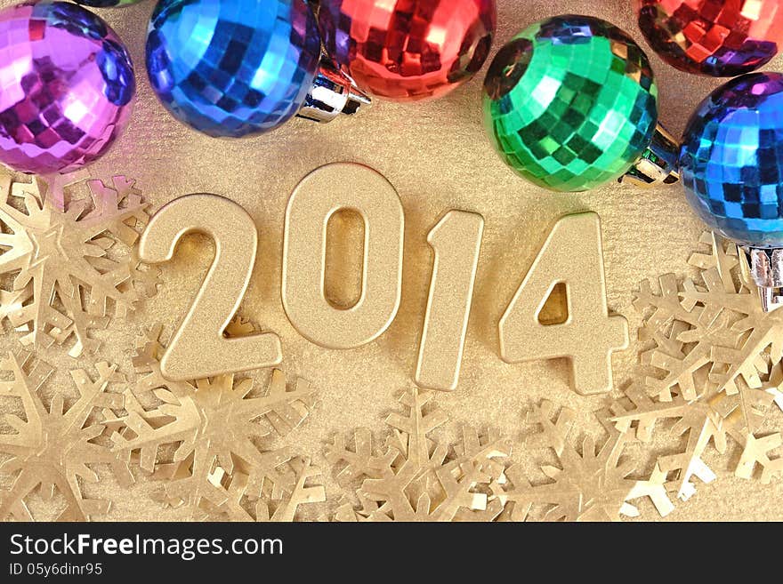 2014 year golden figures on the background of golden snowflakes