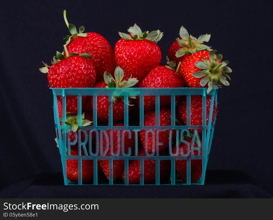 Produce basket of fresh strawberries with black background. Produce basket of fresh strawberries with black background