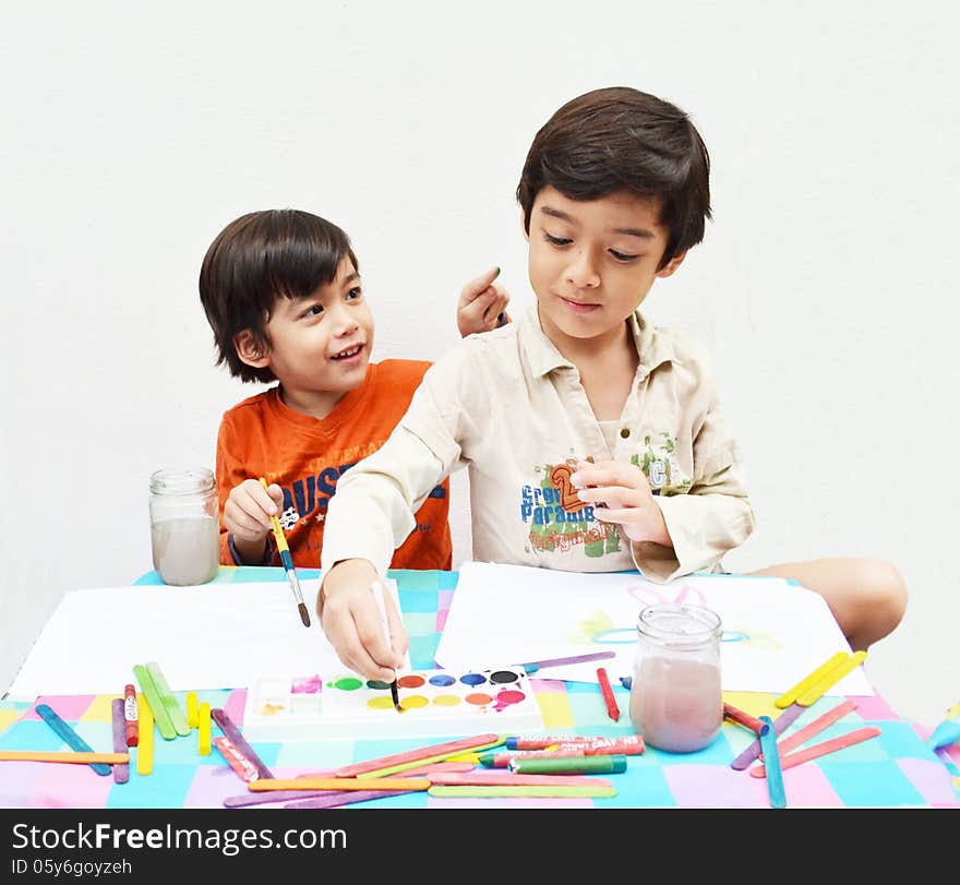 Little sibling boy painting water color together