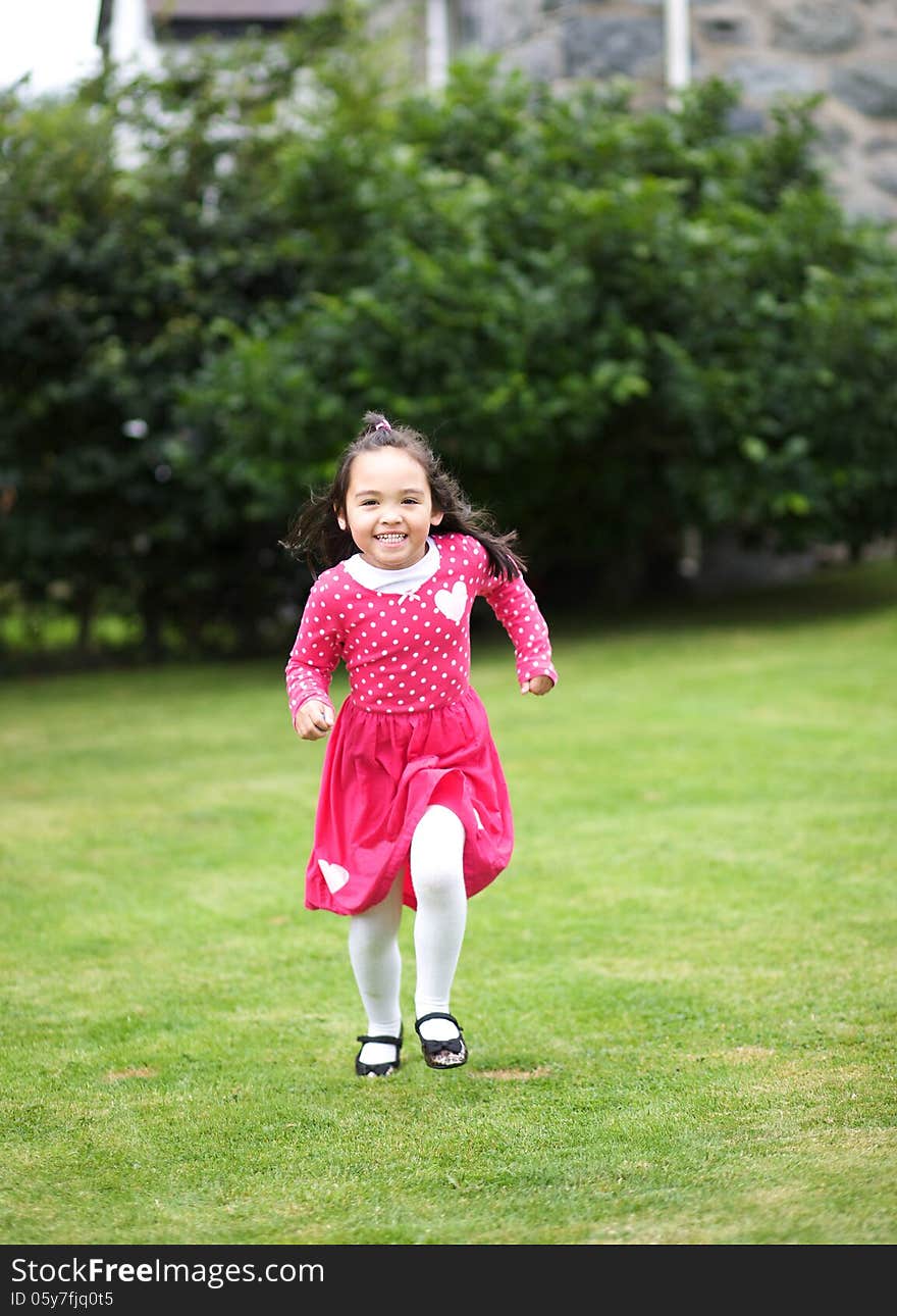 Happy Asian child running in the garden. Happy Asian child running in the garden.