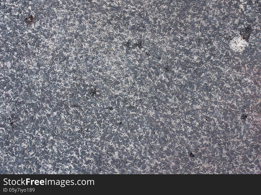 Surface of natural gray spotted stone as background. Surface of natural gray spotted stone as background