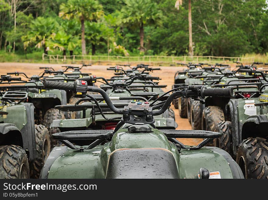 Sports quad bike or atv arranged in row