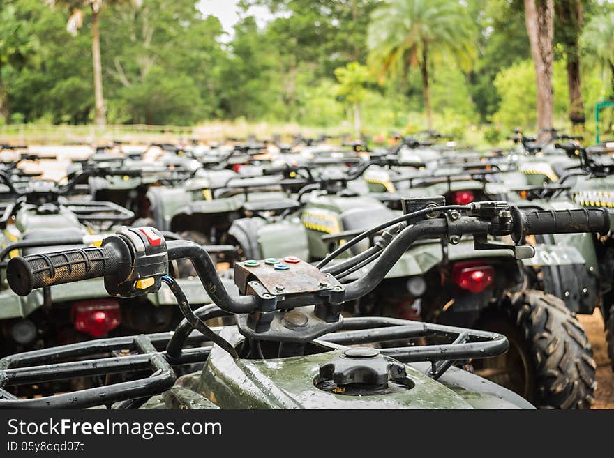 Sports quad bike or atv arranged in row