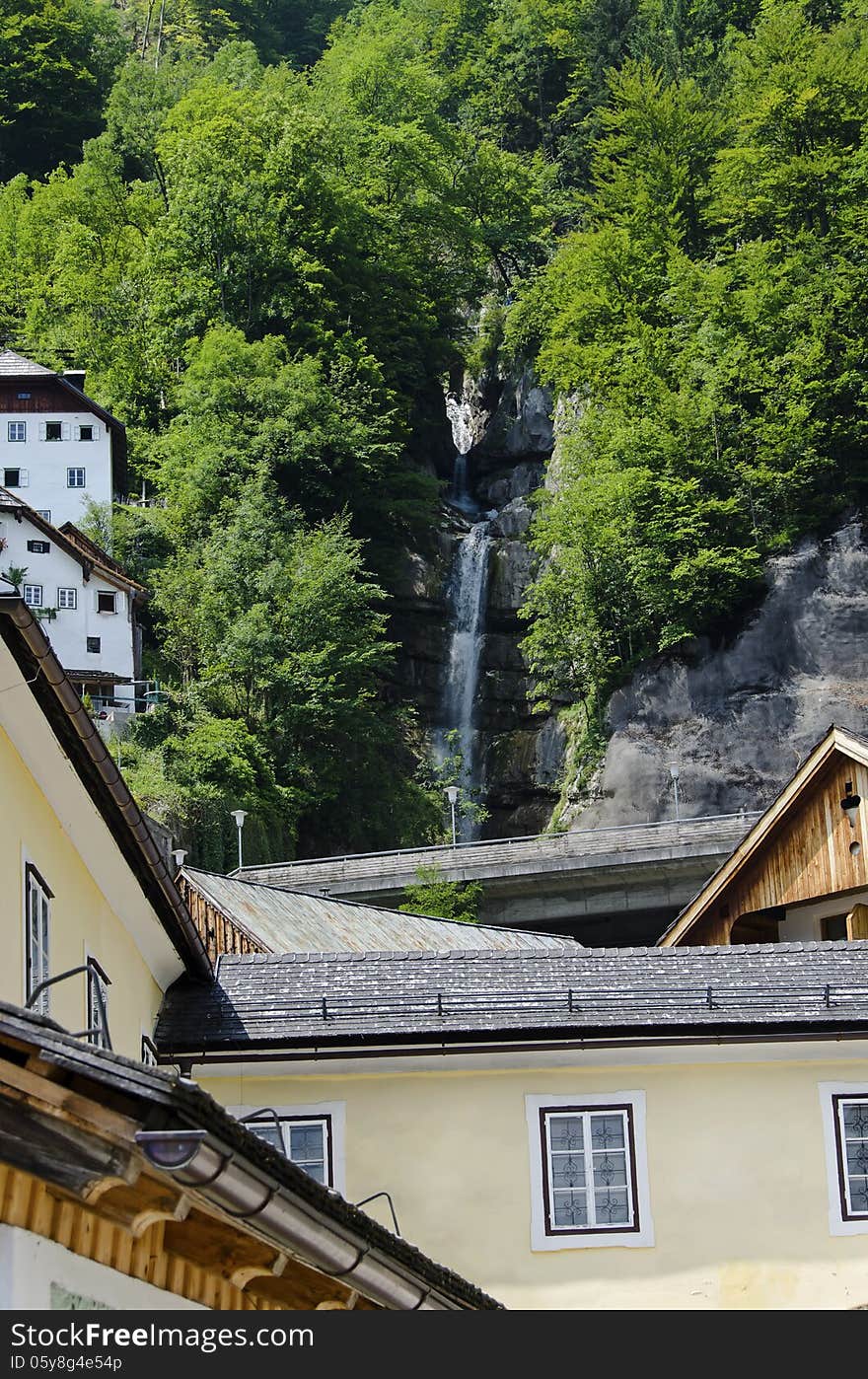 Waterfalls betweens traditional house in Hallstatt  Austria