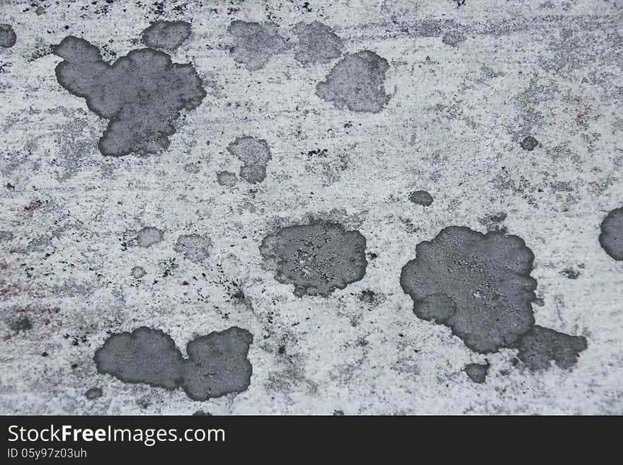 Surface of natural gray stone with spots as background. Surface of natural gray stone with spots as background