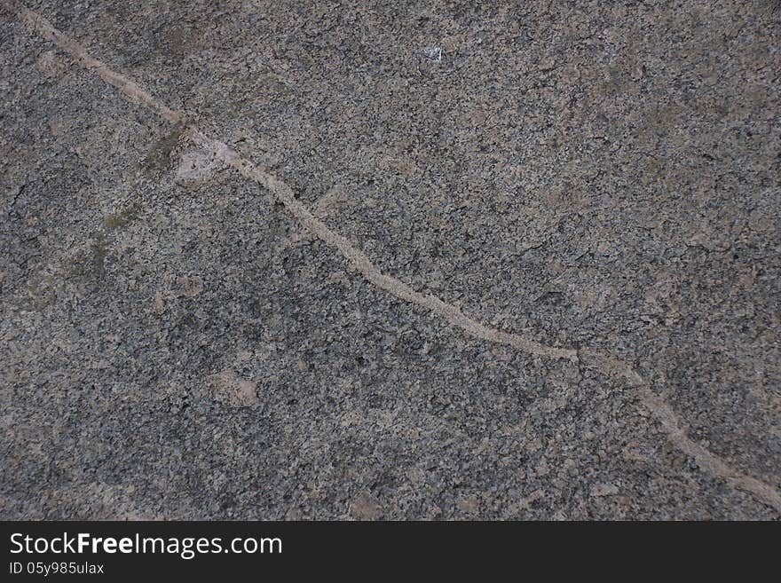 Surface of natural gray stone with transverse line as background. Surface of natural gray stone with transverse line as background