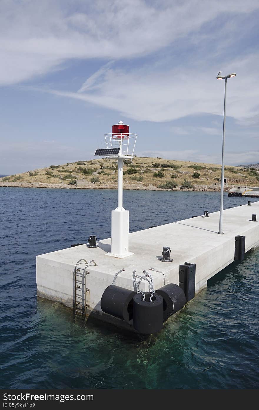 Beacon on solar energy on a white pier in Croatia