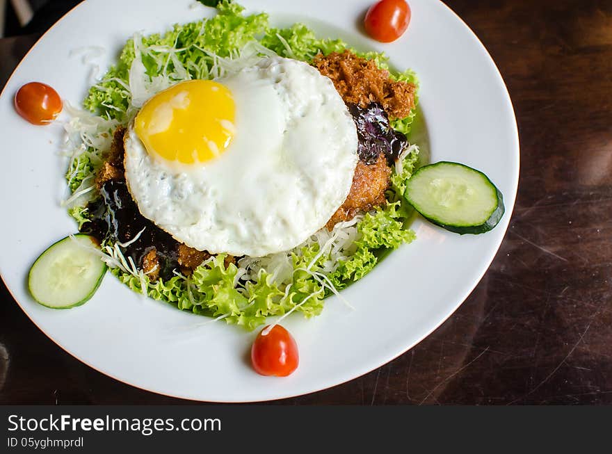 Salad with sunny side up egg on top. Salad with sunny side up egg on top