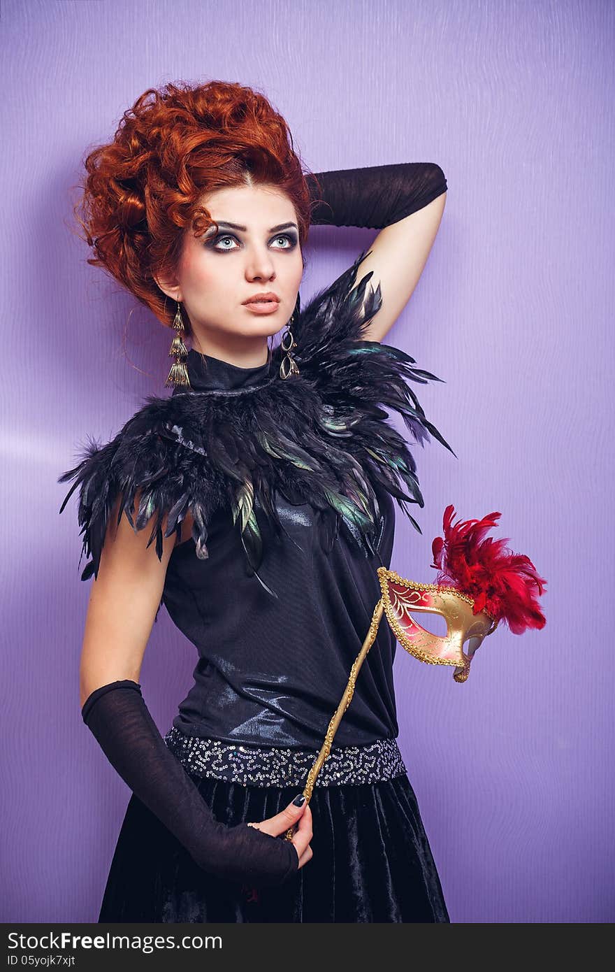 Portrait of red-haired lady in evening dress holding a mask. Portrait of red-haired lady in evening dress holding a mask