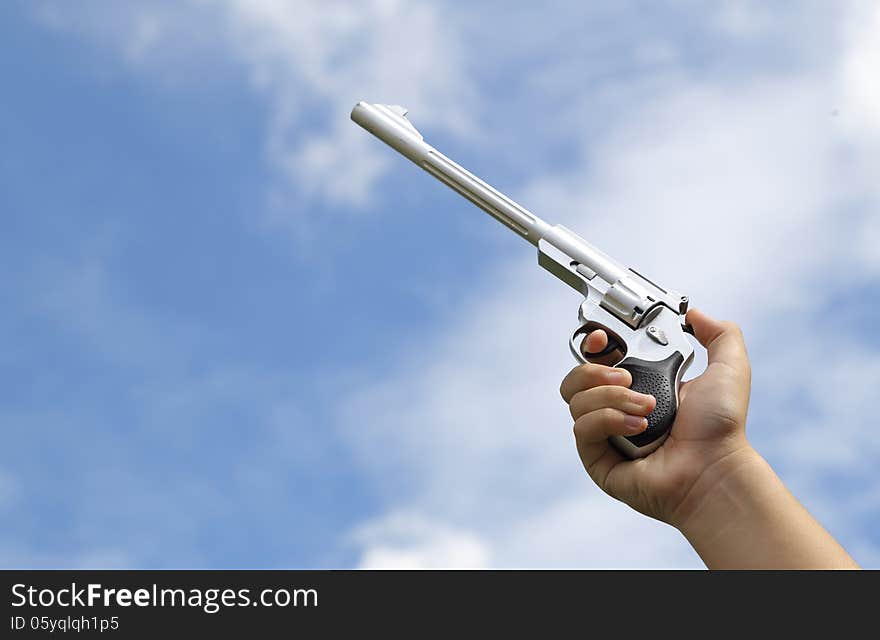 Gun in hand on sky