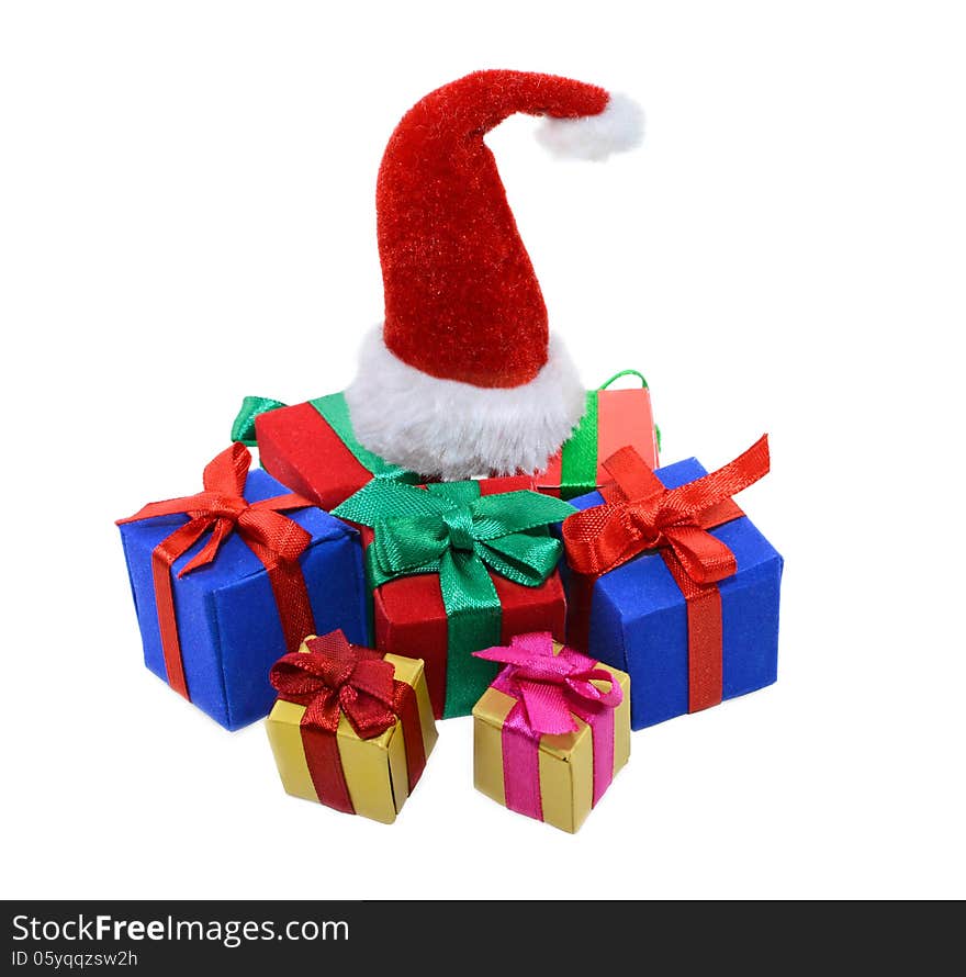 Isolated heap of colorful gift boxes and Santas red hat on top. Isolated heap of colorful gift boxes and Santas red hat on top