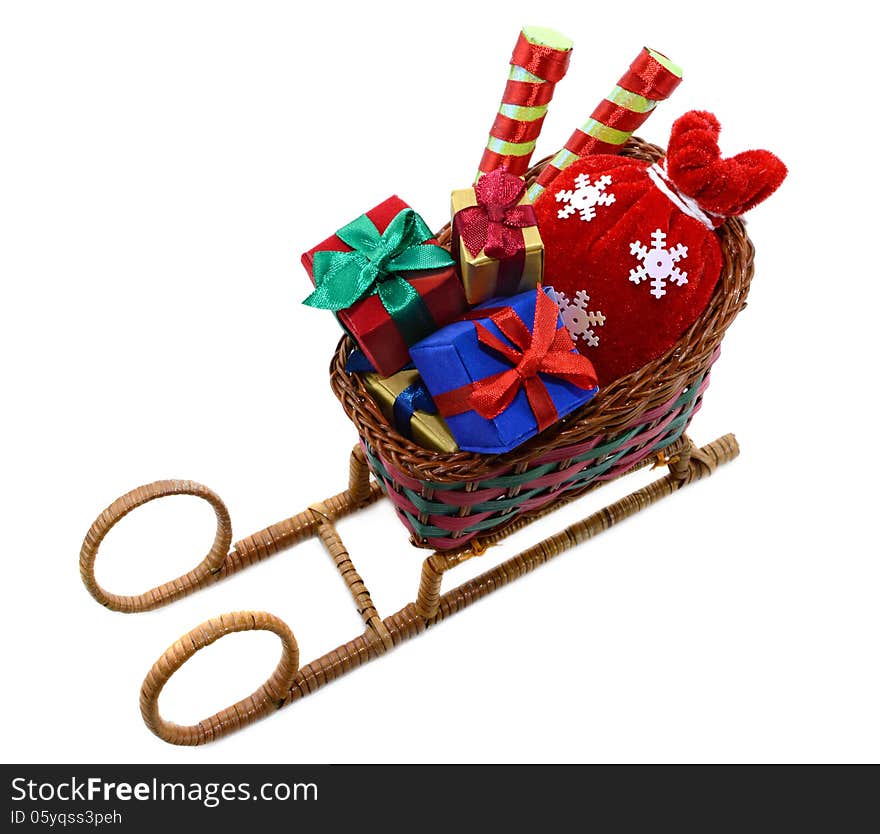 Toy Santas sledges with gifts and red bag isolated