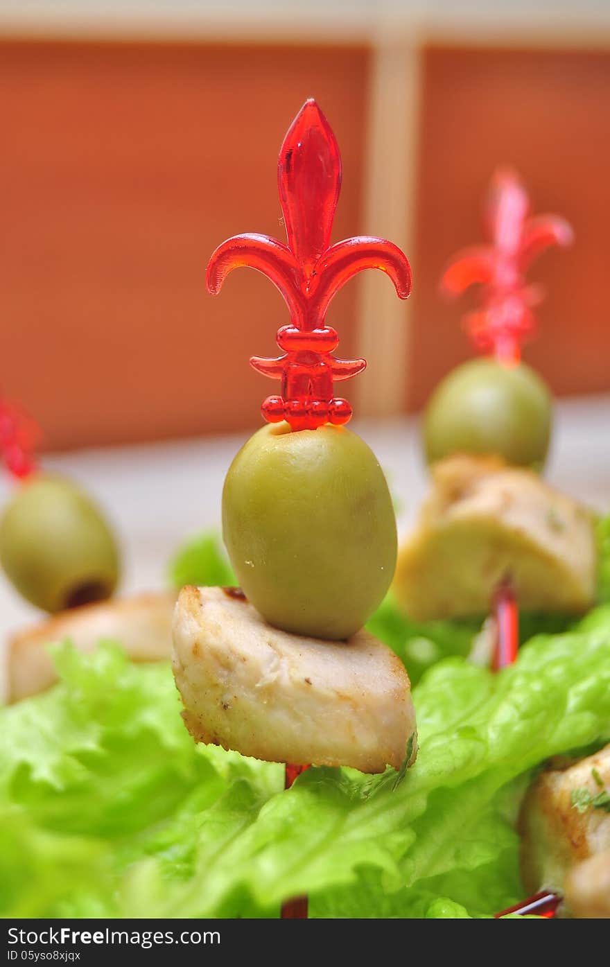 Green olives on sword snack