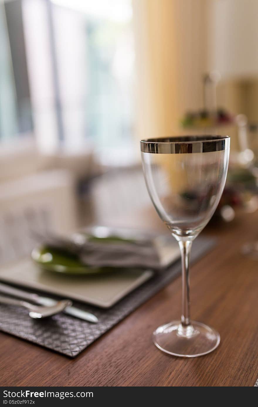 Wine glass with metallic rim on diner table