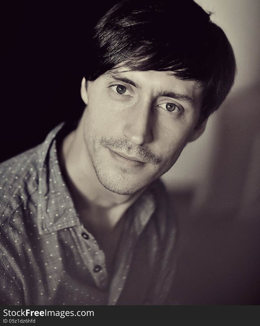 Black-and-white portrait of a guy with a beard and wearing a shirt. Black-and-white portrait of a guy with a beard and wearing a shirt