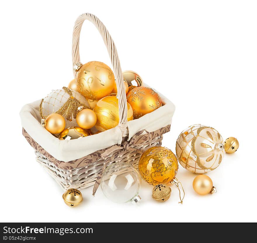 Golden Christmas balls in wicker basket isolated on white background