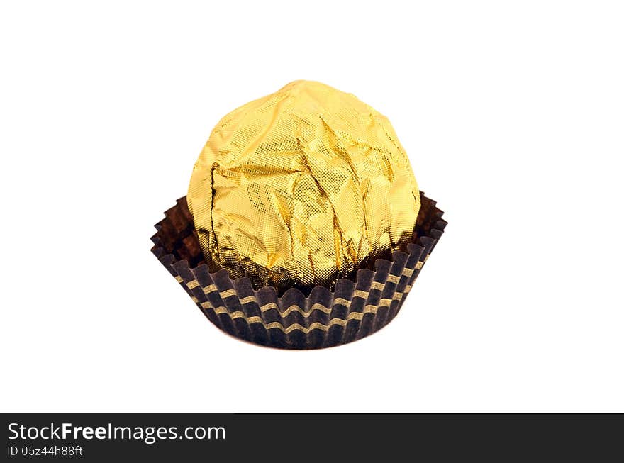 Candy wrapped in gold foil isolated