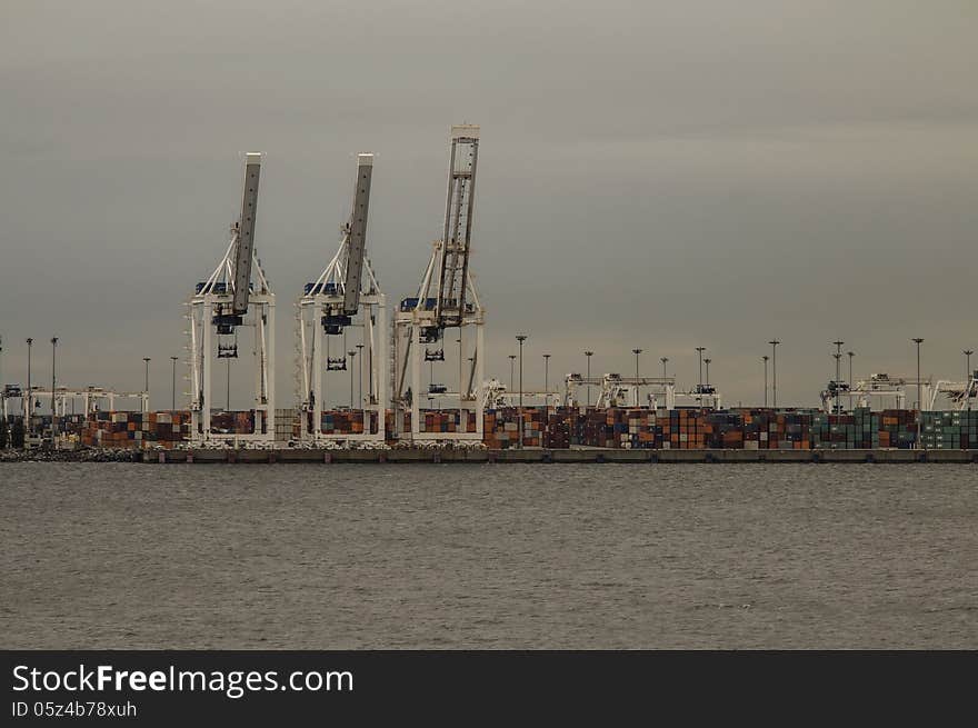 Sea cargo bay with cranes and containers