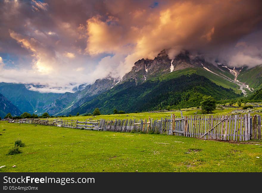 Majestic colorful sunset at the foot of Mt. Ushba. Upper Svaneti, Georgia, Europe. Caucasus mountains. Beauty world.