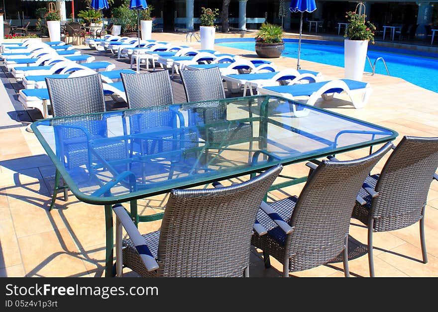 Rattan furniture at patio near pool