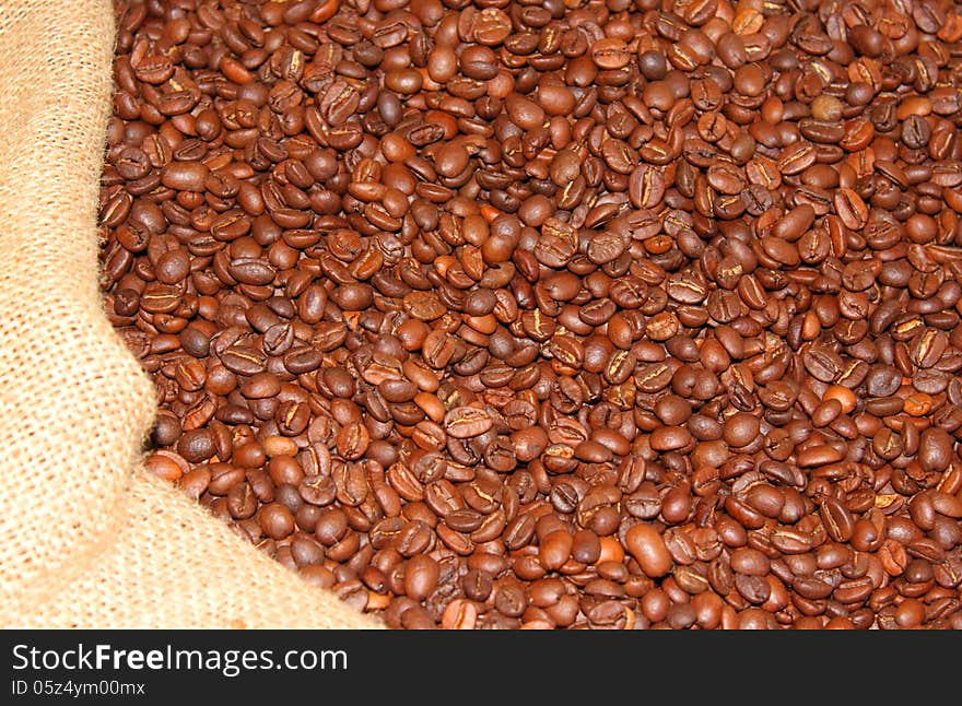 Roasted coffee beans in burlap sack